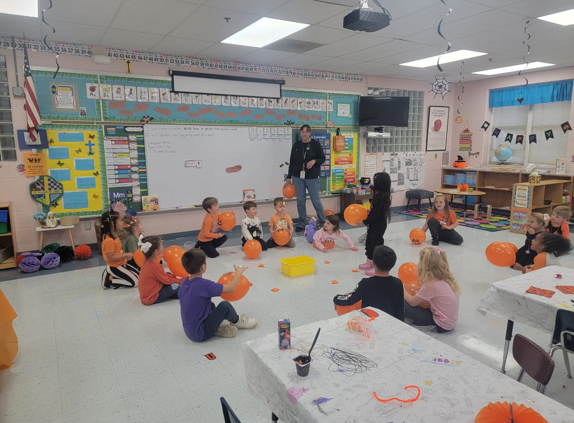 Teacher reading to students at Archbishop Neale School